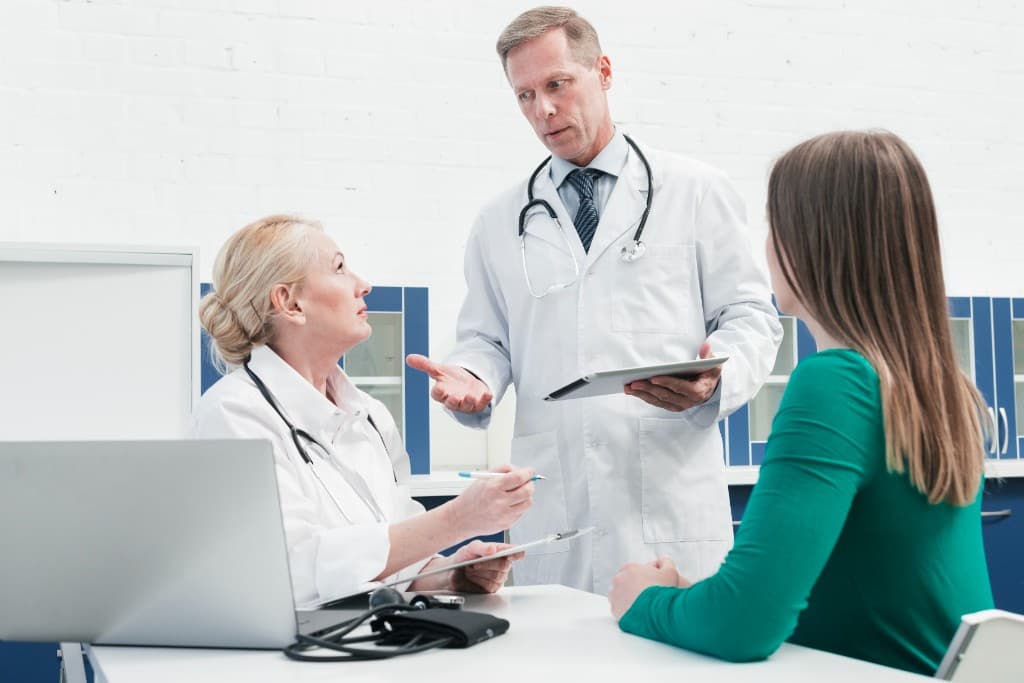Healthcare professionals consulting with a patient in a modern clinic